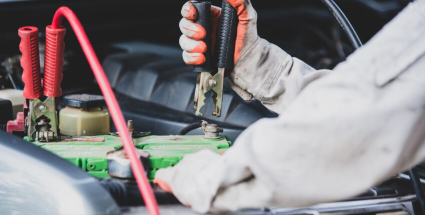 Mechanic charging a car's battery