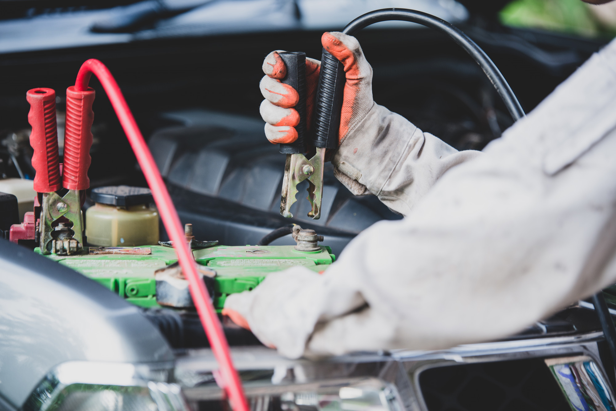 Mechanic charging a car's battery